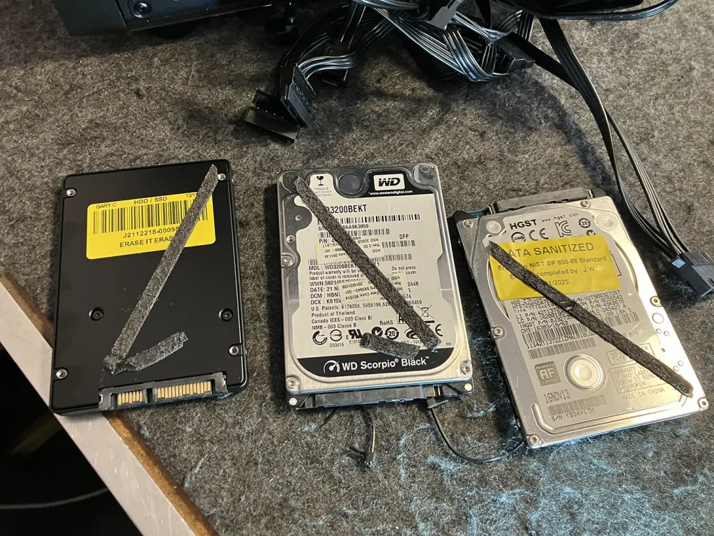 An angled perspective showing the three 2.5" drives that were stuck together with double-sided tape. This is a clear example of a terrible Budget Gaming PC build, which featured bad cables and components held together with tape, that Bluesdigital advised returning.