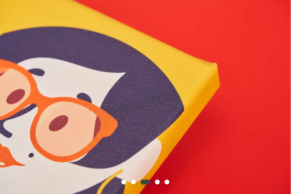 A close-up of the corner of a colourful canvas print. The design is of a graphic of a smiling lady with dark hair wearing orange glasses.