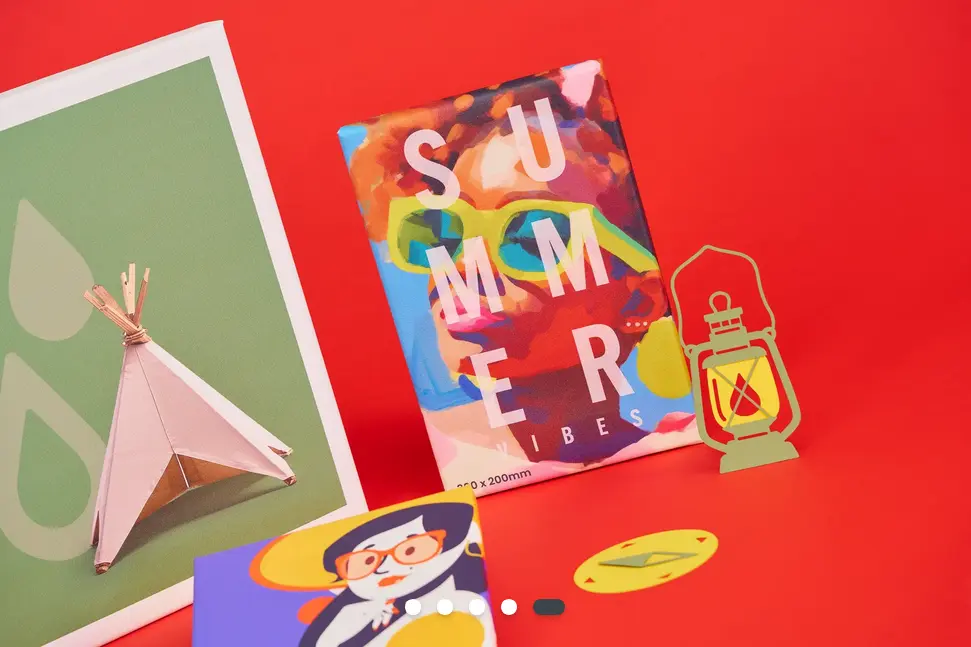 A selection of canvas prints against a red background. One has the words summer vibes over a painting of a face with bright yellow sunglasses.