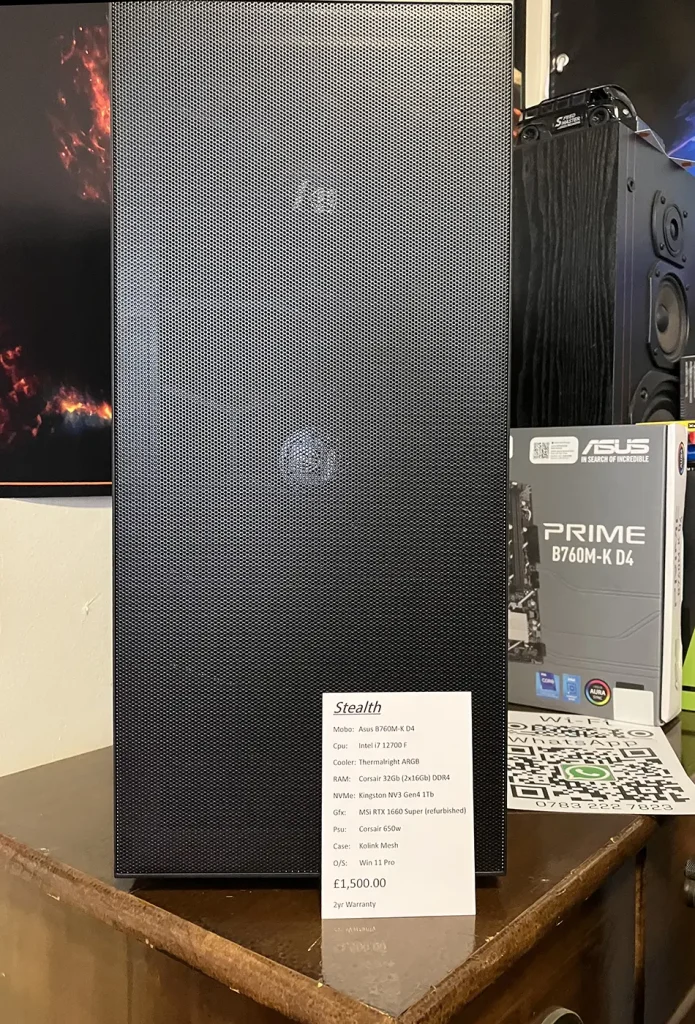 A photo of the PC - you can clearly see the  Kolink Observatory HF Mesh Mid-Tower case, on the workbench at Bluesdigital with a sign showing its components and price.